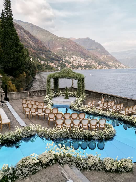 A ceremony set above the sea, wrapped in a ribbon of white flowers