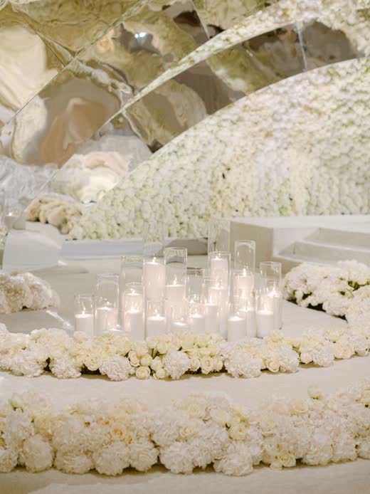 Mounds of white flowers around clear glass